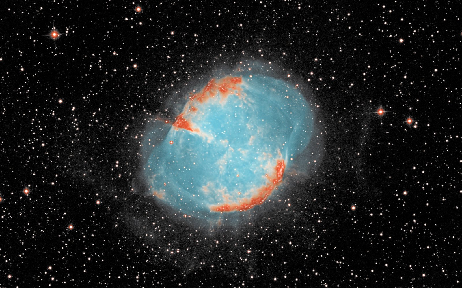 The Dumbbell Nebula: a blue glowing shell with orange lobes