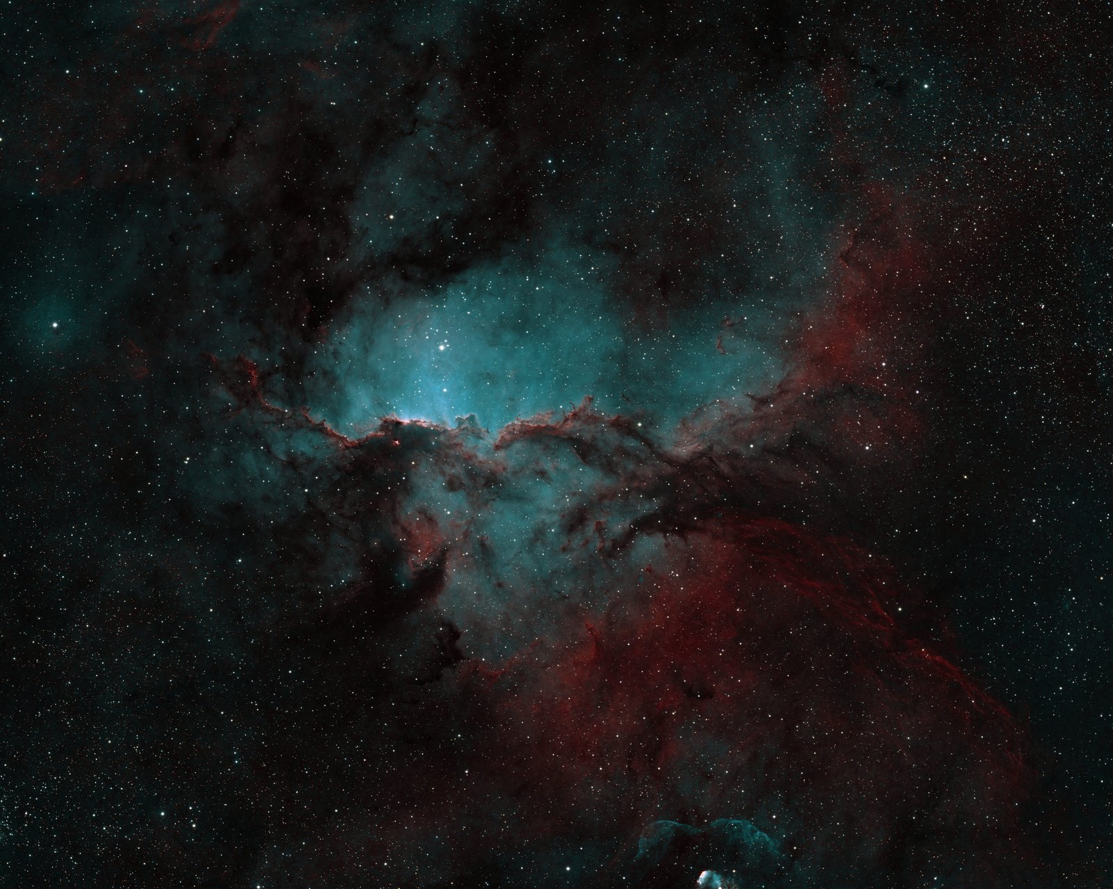 NGC 6188 in the Hubble palette: gold and blue clouds with dark dust